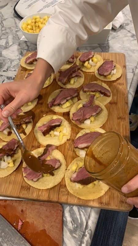 Saucing duck tostadas