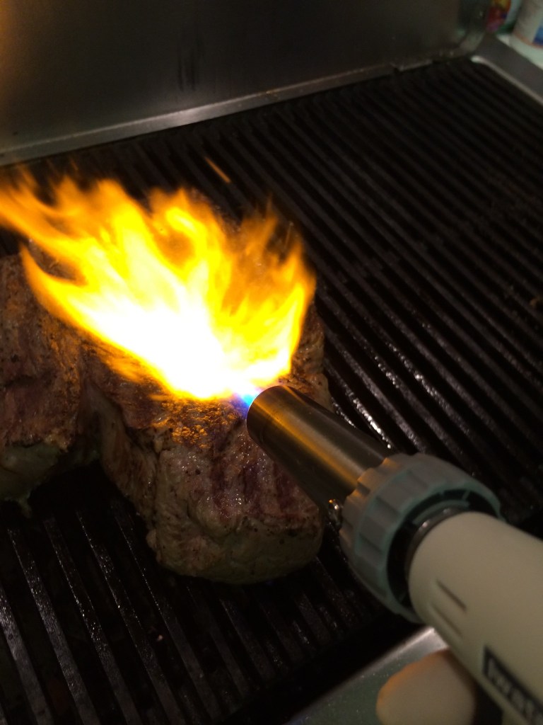 Torch searing steak