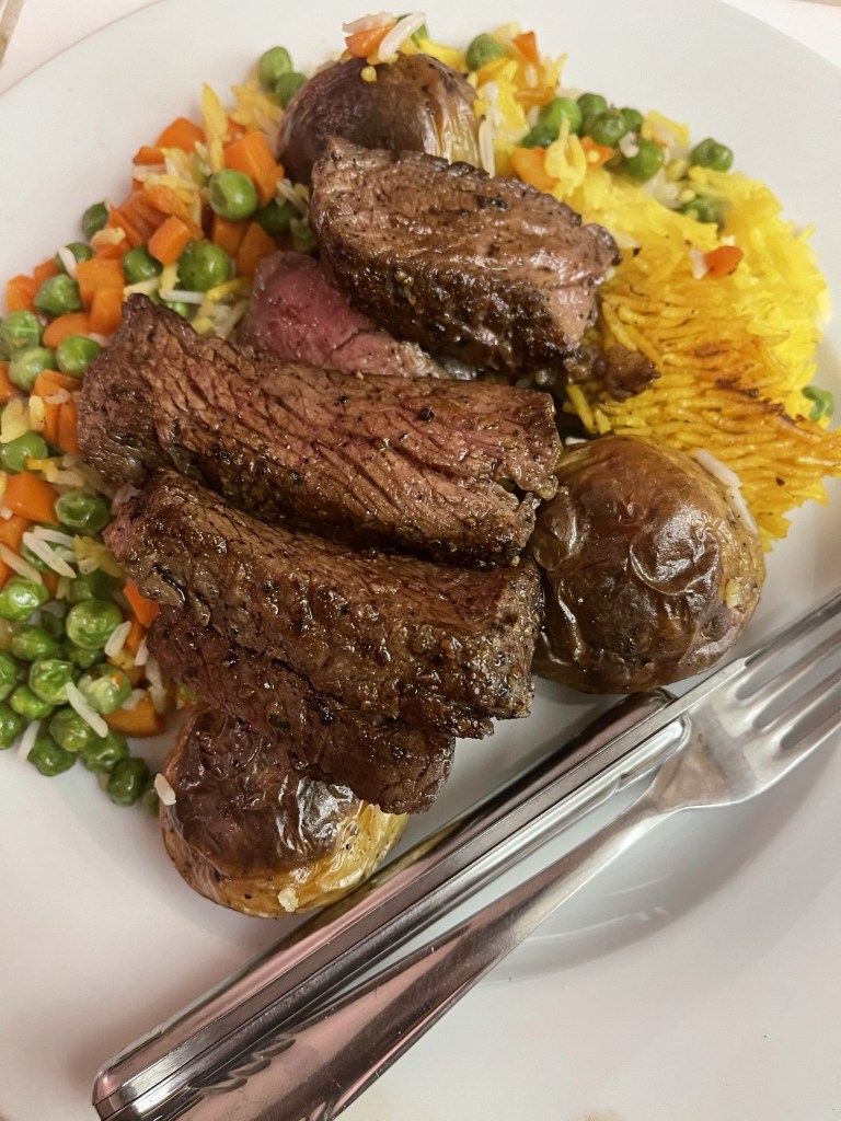 Sliced steak with saffron rice